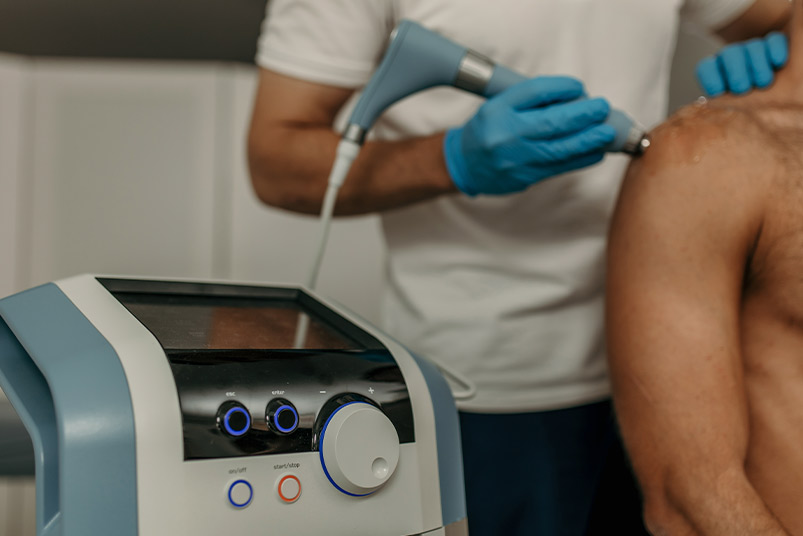 A man undergoing laser treatment on his chest, highlighted in the 2026 Buyers Guide for Clinics about Shockwave Machines.