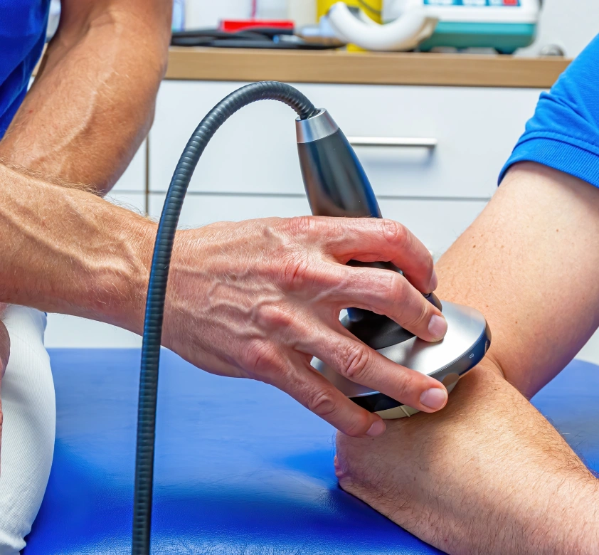 Therapist performing shockwave therapy